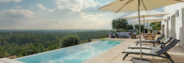 Infinity edge pool installation in Surrey with seamless vanishing edge and panoramic countryside views